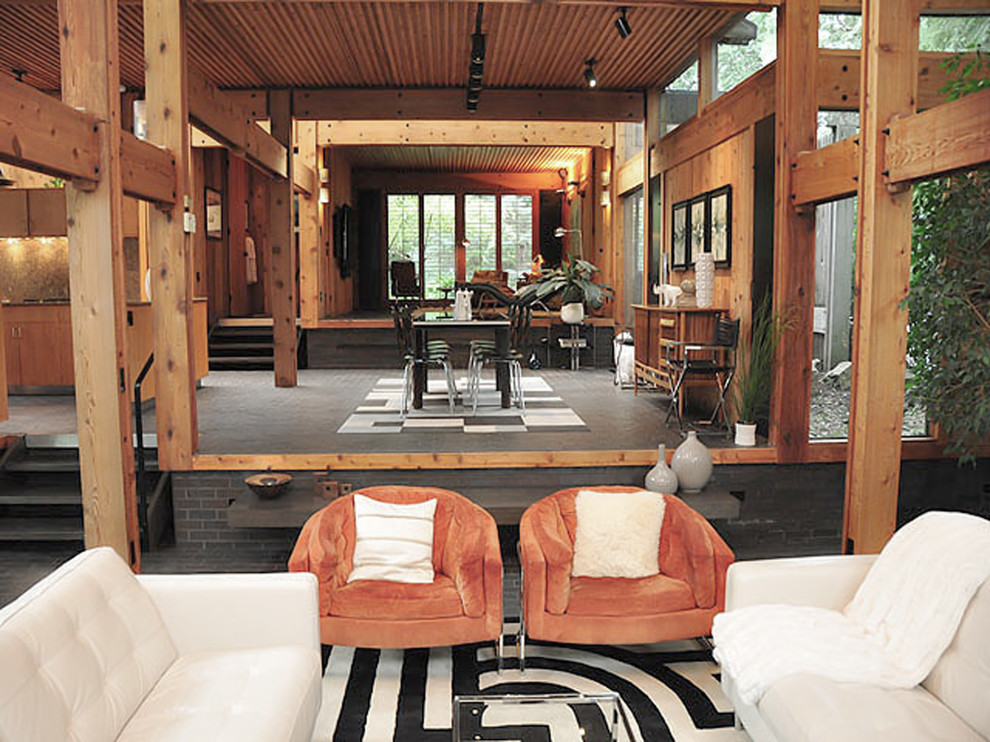 Esempio di un ampio soggiorno minimalista aperto con camino classico e cornice del camino in mattoni