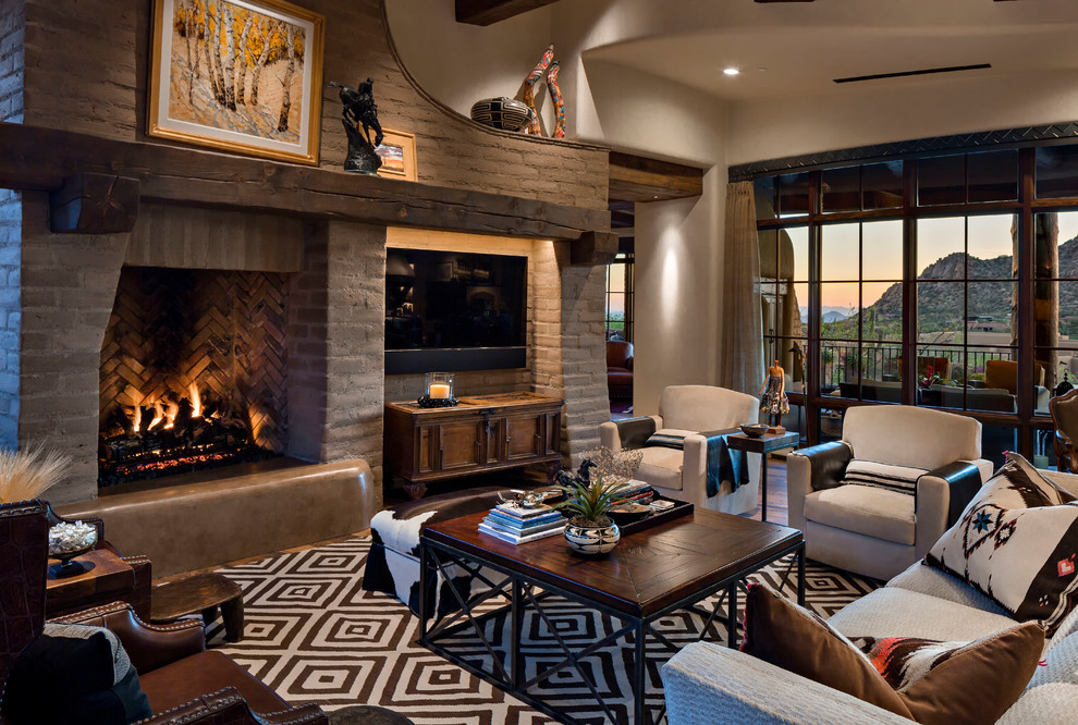 Living room - large southwestern formal and open concept medium tone wood floor and brown floor living room idea in Phoenix with beige walls, a standard fireplace, a stone fireplace and a media wall