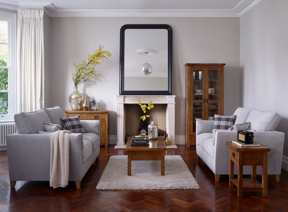 Example of a classic formal dark wood floor living room design in Wiltshire with gray walls, a standard fireplace and no tv