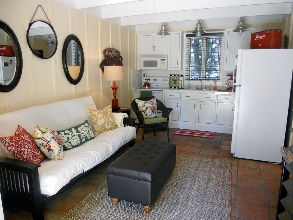 На фото: маленькая открытая гостиная комната в стиле неоклассика (современная классика) с желтыми стенами и полом из терракотовой плитки без камина, телевизора для на участке и в саду
