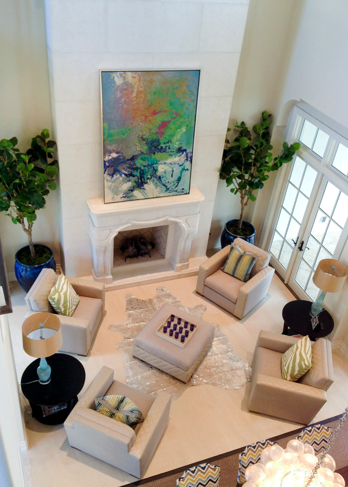 This is an example of a medium sized bohemian formal enclosed living room in Tampa with white walls, porcelain flooring, a standard fireplace, a stone fireplace surround, no tv and beige floors.