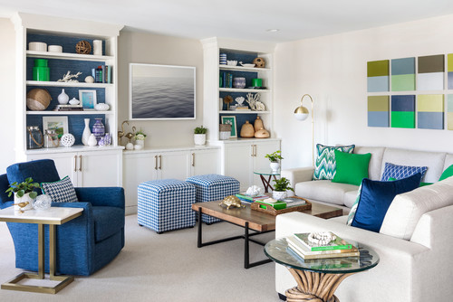 Bright living room with built-in white cabinets and bold pops of blue and green accents, decorated with patterned ottomans, modern artwork, and coastal-inspired accessories, reflecting stylish best kitchen cabinet colors Canada home design trends.