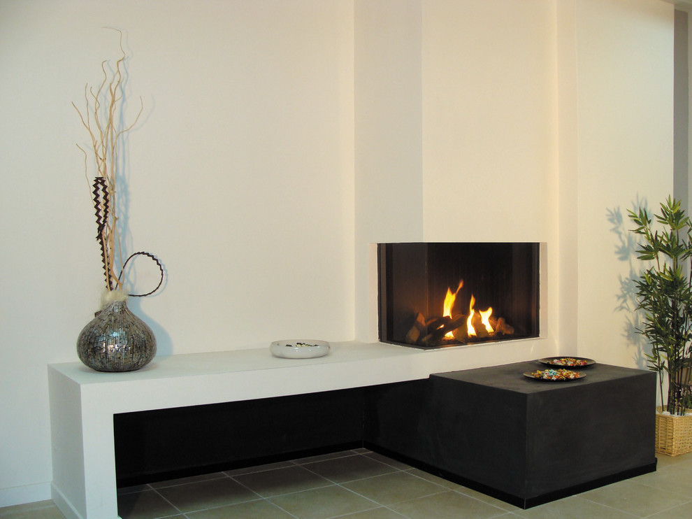 Example of a trendy ceramic tile living room design in Denver with white walls, a corner fireplace and a plaster fireplace