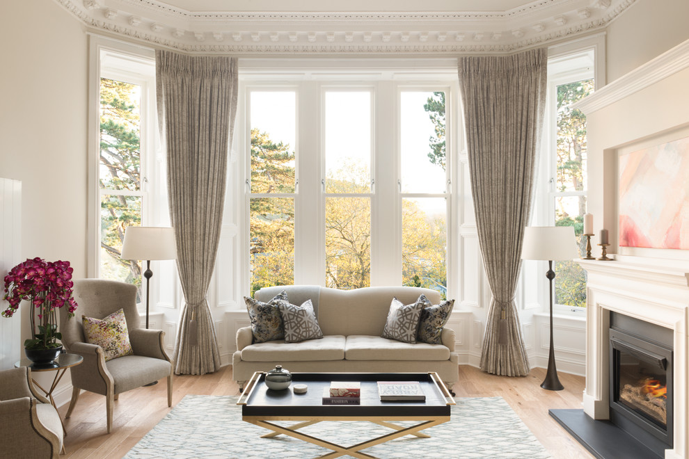 Design ideas for a classic living room in Edinburgh with grey walls, medium hardwood flooring and a standard fireplace.