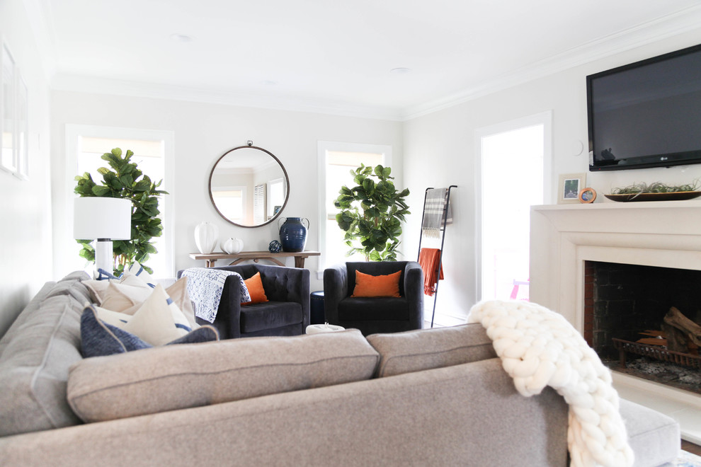 Transitional enclosed living room photo in Chicago with gray walls, a standard fireplace and a wall-mounted tv