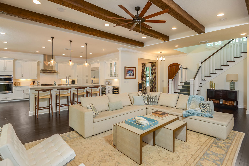 This is an example of a large traditional open plan living room in Tampa with beige walls, dark hardwood flooring and brown floors.