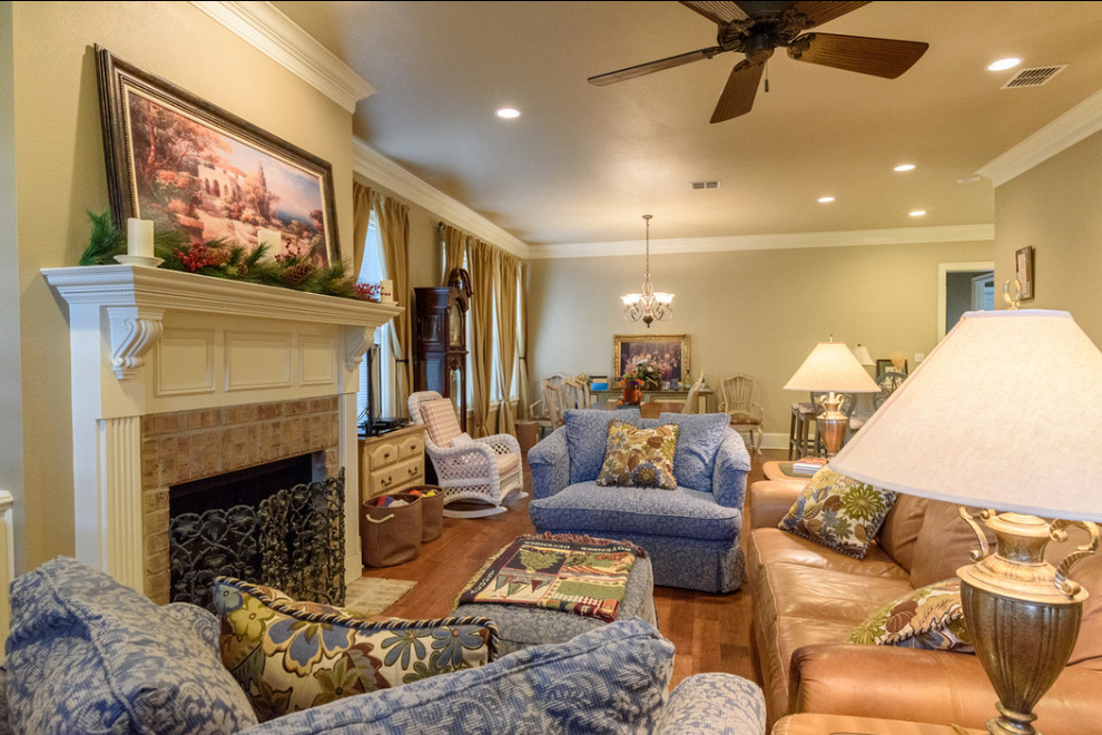 Mid-sized southwest open concept medium tone wood floor and brown floor living room photo in New Orleans with beige walls, a standard fireplace, a tile fireplace and no tv