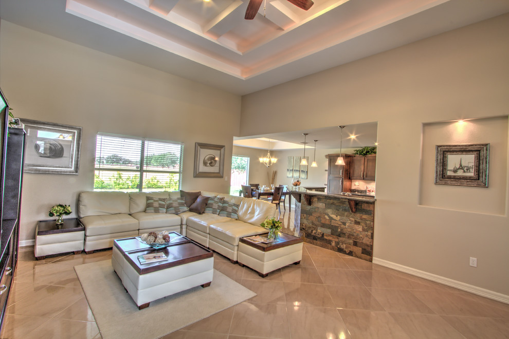 Example of a large trendy open concept porcelain tile living room design in Austin with beige walls and no tv