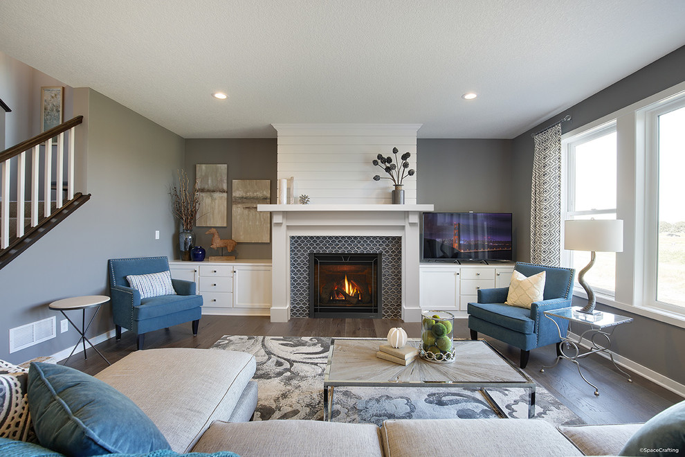 Medium sized traditional formal enclosed living room in Boston with grey walls, dark hardwood flooring, a standard fireplace, a tiled fireplace surround, no tv and brown floors.