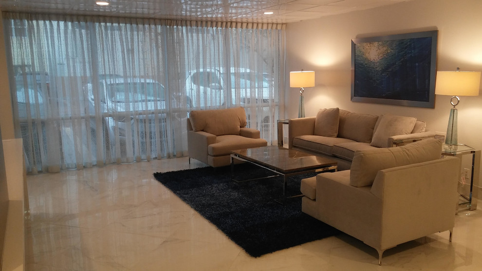 This is an example of a medium sized traditional formal enclosed living room in Miami with beige walls, marble flooring and grey floors.