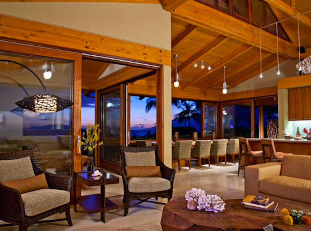 This is an example of a large world-inspired formal open plan living room in Hawaii with white walls, medium hardwood flooring and a freestanding tv.