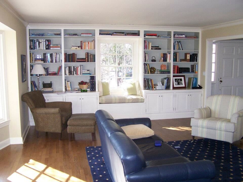 Example of a classic formal and enclosed medium tone wood floor living room design in New York with beige walls and no tv
