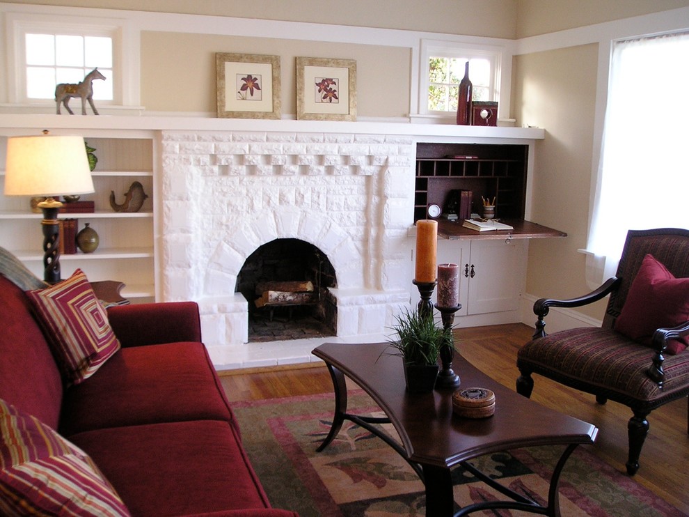 Example of a small classic formal and enclosed light wood floor living room design in San Francisco with beige walls, a standard fireplace, a brick fireplace and no tv
