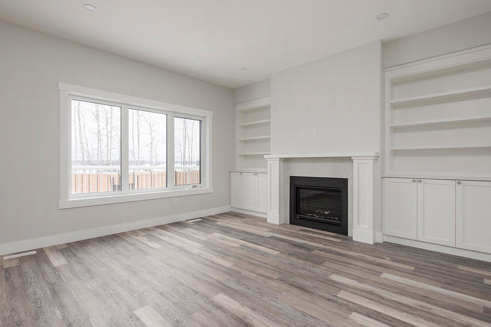 Example of a large transitional open concept medium tone wood floor and brown floor living room design in Calgary with white walls, a standard fireplace and a metal fireplace
