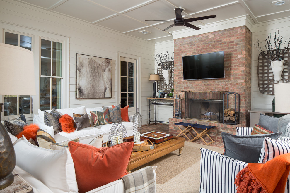Living room - traditional brick floor living room idea in Atlanta with a standard fireplace, a brick fireplace and a wall-mounted tv