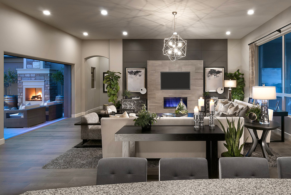Inspiration for a large eclectic formal and open concept porcelain tile and gray floor living room remodel in Phoenix with gray walls, a ribbon fireplace, a stone fireplace and a wall-mounted tv