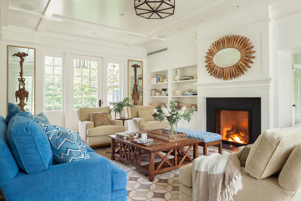 Example of a beach style living room design in Boston with white walls and a standard fireplace