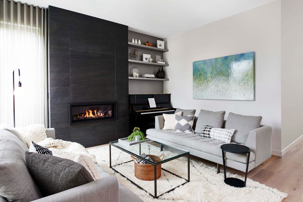 Medium sized contemporary formal open plan living room in Vancouver with white walls, light hardwood flooring, a ribbon fireplace and a tiled fireplace surround.