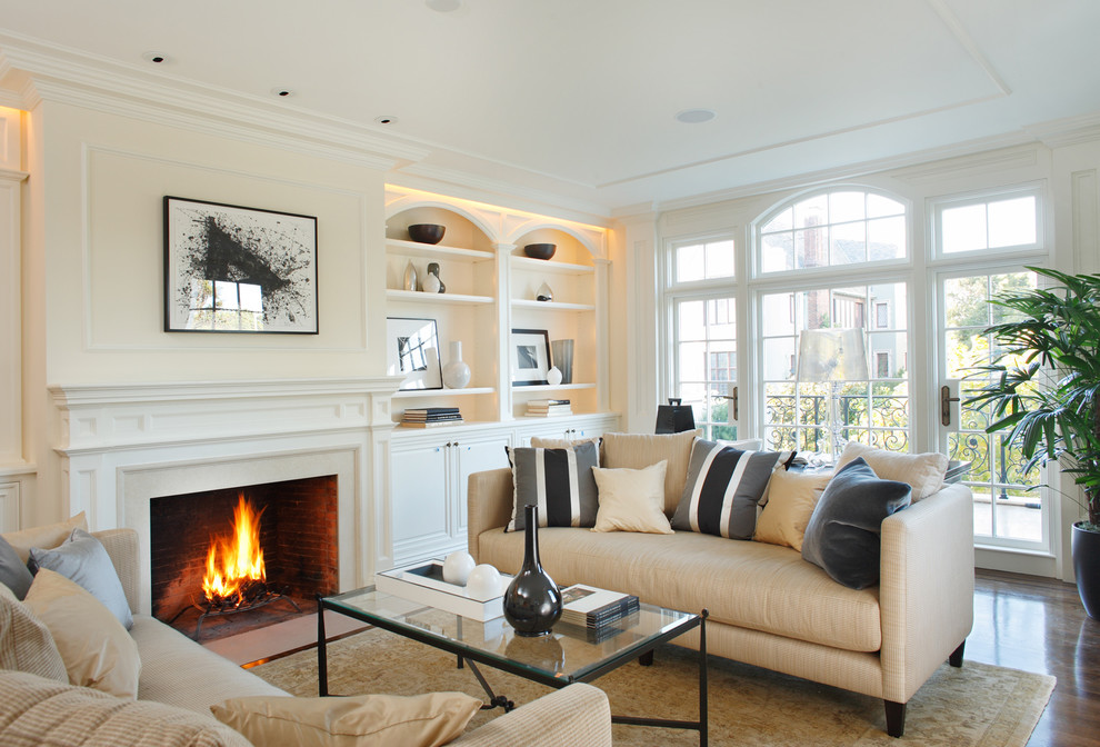 Mid-sized trendy formal and enclosed dark wood floor living room photo in San Francisco with beige walls, a standard fireplace, no tv and a plaster fireplace