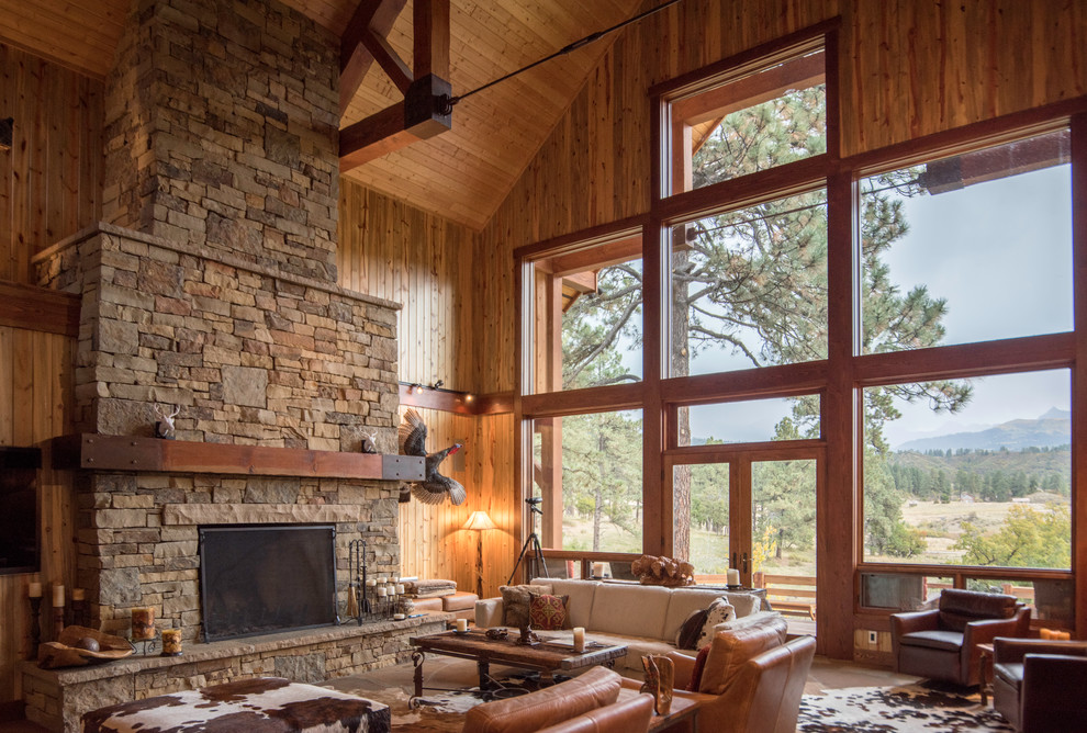 Inspiration for a large rustic formal open plan living room in Albuquerque with terracotta flooring, a ribbon fireplace, a stone fireplace surround and a wall mounted tv.