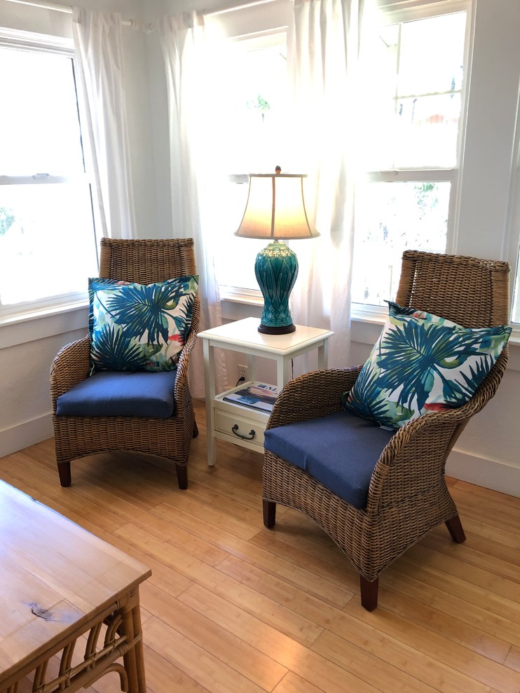 Photo of a small nautical open plan living room in Hawaii with white walls, bamboo flooring, no fireplace and no tv.