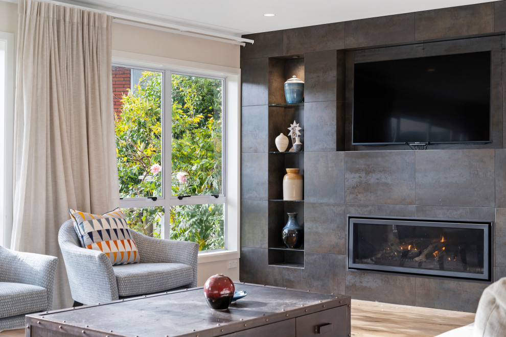 Mid-sized trendy open concept medium tone wood floor living room photo in Auckland with a standard fireplace, a tile fireplace and a wall-mounted tv