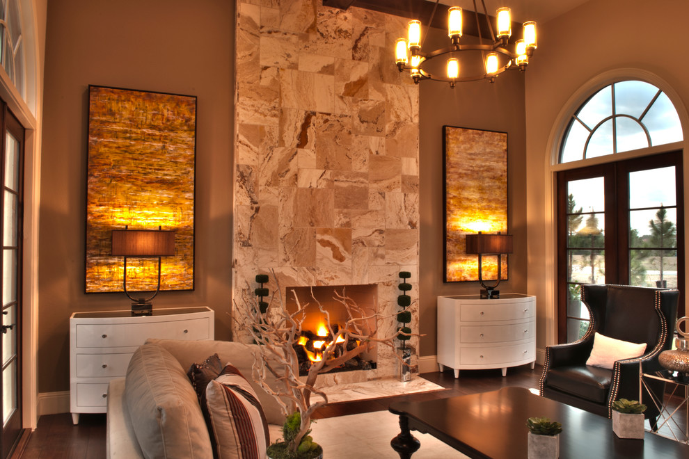 Imagen de salón para visitas abierto mediterráneo sin televisor con marco de chimenea de piedra, paredes beige, suelo de madera oscura y todas las chimeneas
