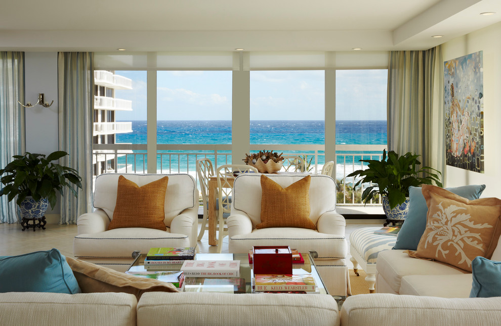 Photo of a large traditional open plan living room in Miami with blue walls, travertine flooring and white floors.