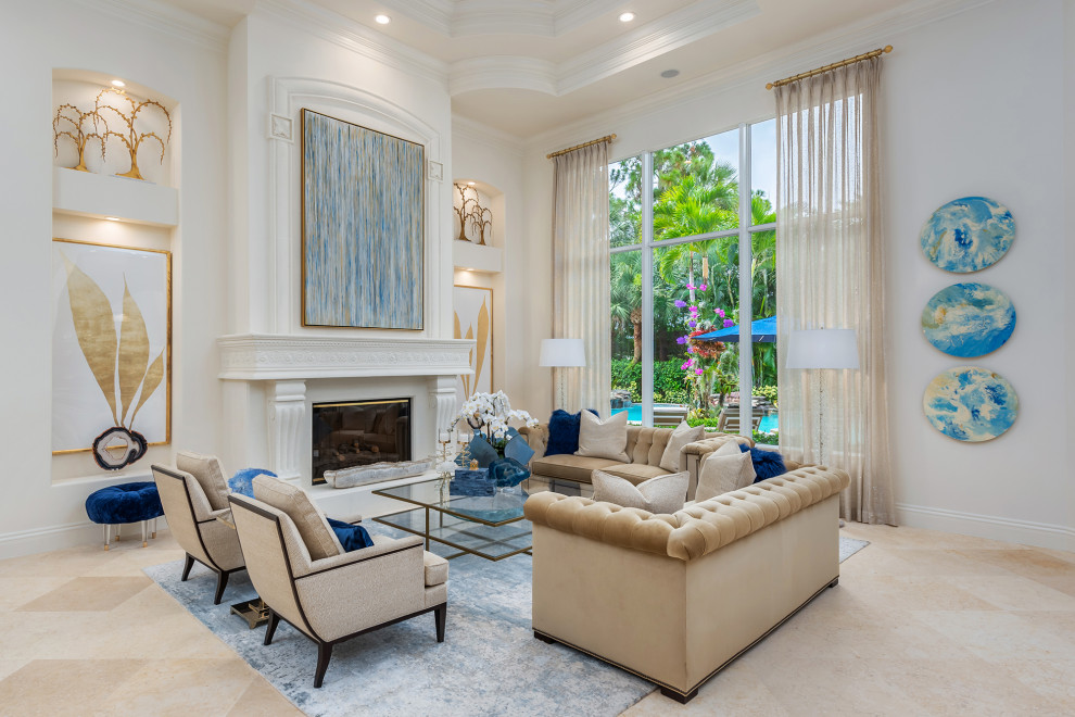 Example of a large tuscan open concept marble floor, beige floor and coffered ceiling living room design in Miami with white walls, a standard fireplace, a plaster fireplace and no tv