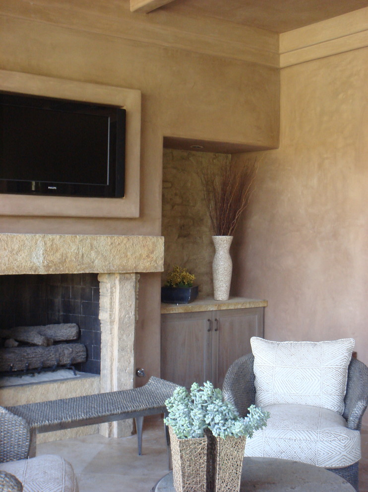 Inspiration for a large southwestern formal and open concept slate floor living room remodel in San Francisco with beige walls, a standard fireplace, a stone fireplace and a wall-mounted tv