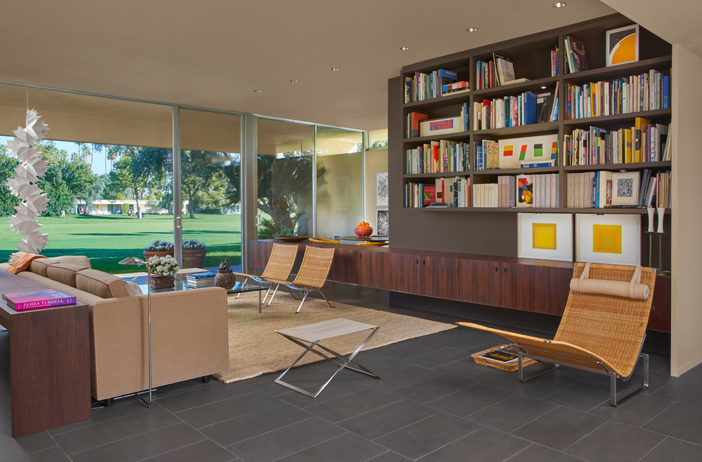This is an example of a medium sized midcentury open plan living room in Chicago with a reading nook, beige walls, porcelain flooring, no fireplace, no tv and brown floors.