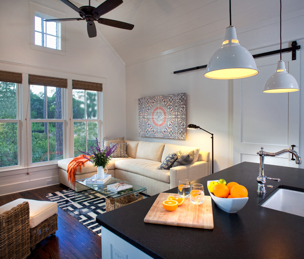 Small classic open plan living room in Charleston with white walls, medium hardwood flooring and feature lighting.