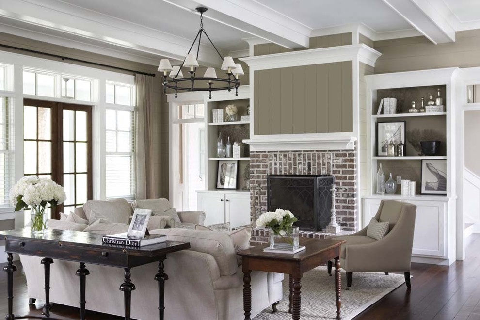 Inspiration for a large timeless open concept dark wood floor living room remodel in Charleston with beige walls, a standard fireplace, a brick fireplace and no tv