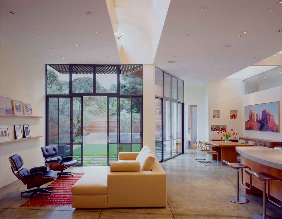 This is an example of a contemporary living room in San Francisco with concrete flooring.