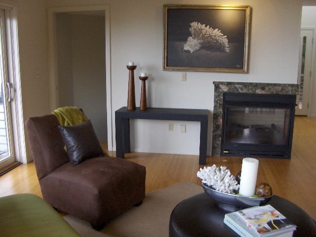 Imagen de salón cerrado bohemio de tamaño medio con chimenea de doble cara y marco de chimenea de piedra