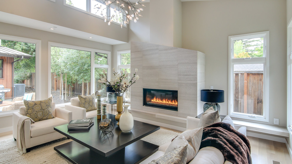 Large contemporary formal enclosed living room in San Francisco with beige walls, light hardwood flooring, a tiled fireplace surround, a ribbon fireplace, no tv and beige floors.
