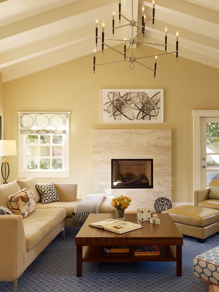 Aménagement d'un grand salon classique fermé avec un mur beige, une cheminée standard, un manteau de cheminée en pierre, un téléviseur indépendant, une salle de réception, moquette, un sol bleu et éclairage.