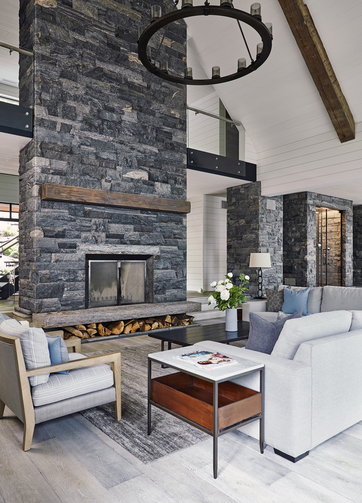 Photo of a large formal open plan living room in Toronto with a wood burning stove and a stone fireplace surround.