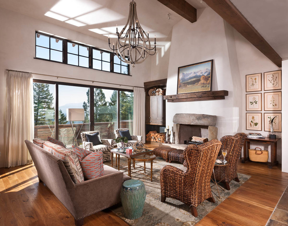 Inspiration for a large rustic open concept medium tone wood floor living room remodel in Other with a stone fireplace and a media wall