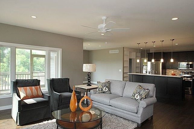 Photo of a medium sized contemporary open plan living room in Cedar Rapids with grey walls, dark hardwood flooring, no fireplace and a wall mounted tv.