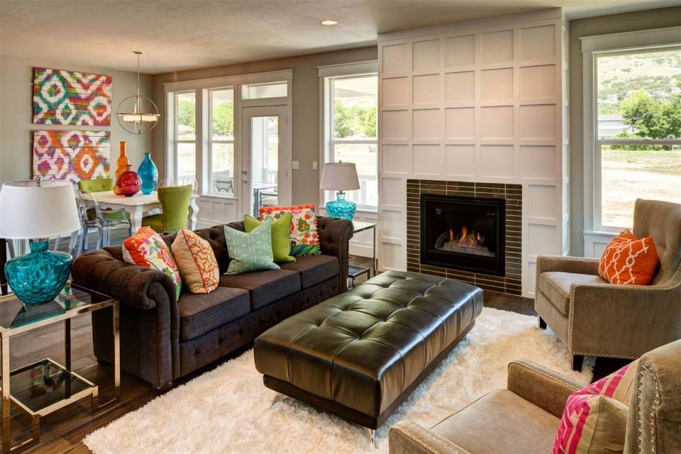 This is an example of a medium sized contemporary formal open plan living room in Salt Lake City with beige walls, medium hardwood flooring, a standard fireplace, a brick fireplace surround, no tv and brown floors.