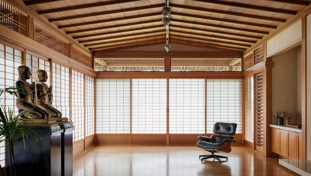 Diseño de salón con rincón musical abierto de estilo zen grande sin televisor con paredes beige, suelo de madera clara, todas las chimeneas y marco de chimenea de metal