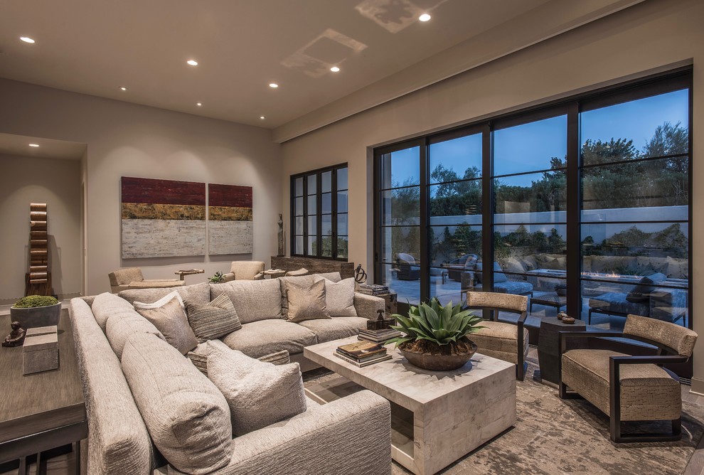 This is an example of a large contemporary open plan living room in Phoenix with beige walls, light hardwood flooring and beige floors.