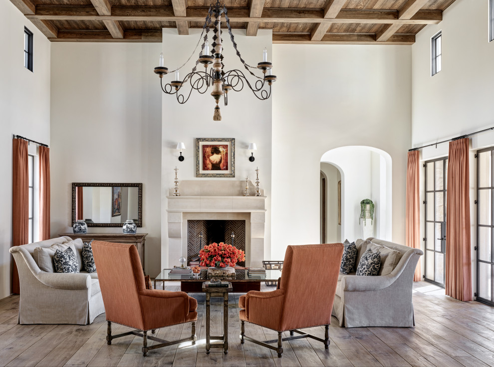 Photo of a mediterranean formal open plan living room in Phoenix with white walls, medium hardwood flooring, a standard fireplace, a stone fireplace surround, no tv, brown floors, a coffered ceiling and a wood ceiling.