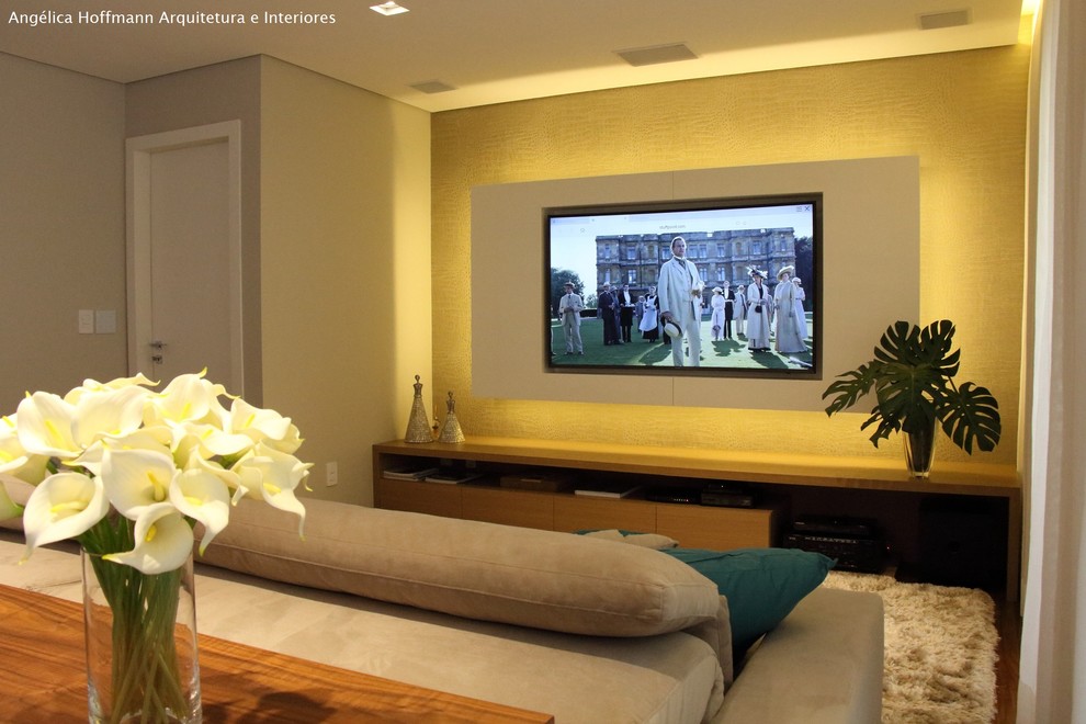 Cette image montre un salon design de taille moyenne et ouvert avec un mur beige, parquet foncé, un téléviseur encastré et un sol marron.
