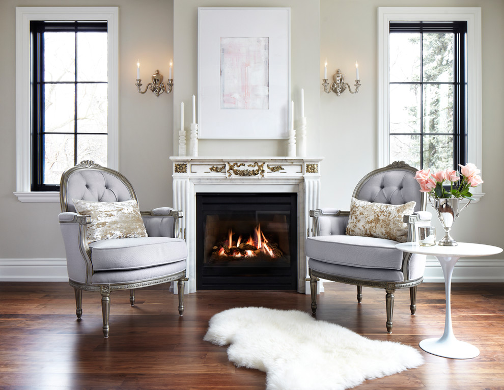 Foto de salón clásico con paredes beige, suelo de madera en tonos medios y todas las chimeneas