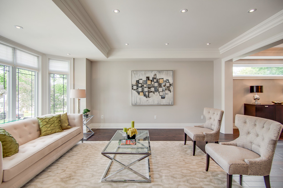 This is an example of a large classic formal enclosed living room in Toronto with dark hardwood flooring, brown floors, grey walls, no fireplace and no tv.