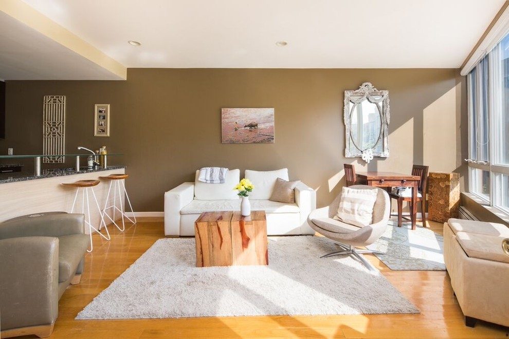 Immagine di un piccolo soggiorno chic aperto con sala formale, pareti marroni e parquet chiaro
