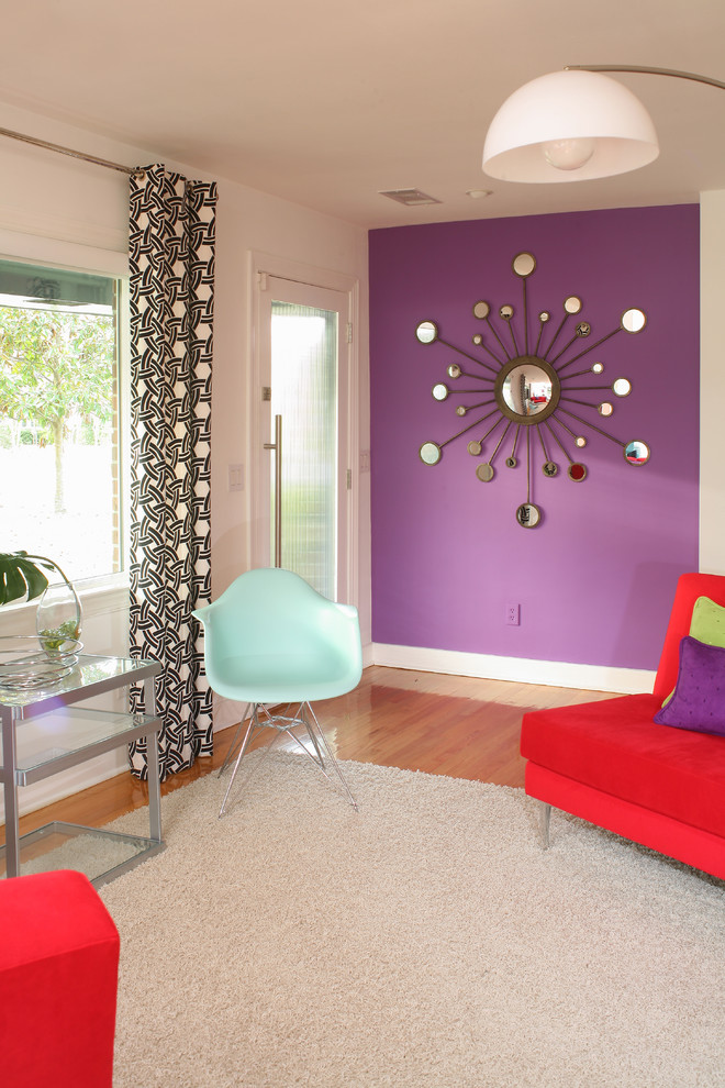 Inspiration for a small eclectic open concept medium tone wood floor living room remodel in Charleston with white walls