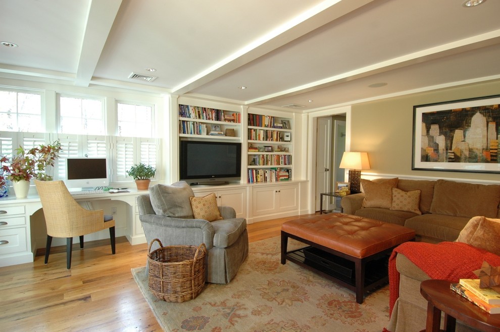 Example of a large classic enclosed medium tone wood floor and brown floor living room design in Boston with green walls and a media wall